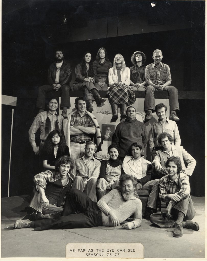 full cast and director pose together in this warm, old photograph. Paul Thompson lies on the floor sideways smiling