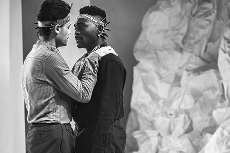 Orestes, played by Kwaku and Pylades, played by Nathaniel, look longingly and sadly into each other's eyes