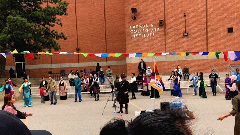 In front of PCI tibetan prayer flags are hung and the community in their traditional dresses come out to dance in a circle