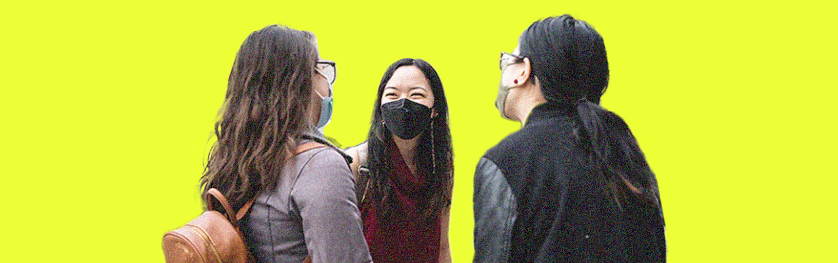 three people smile and talk with each other wearing a mask, in comfortable casual clothing. Bright yellow banner.